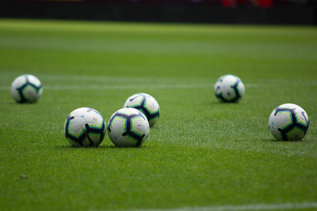 footballs on a pitch